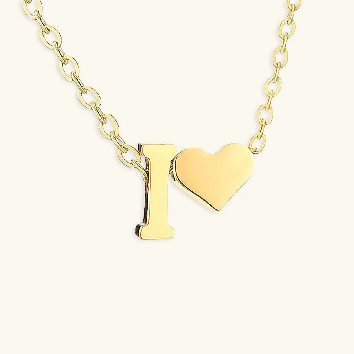 Seraya 14k yellow-gold PVD initial I and heart necklace on an ivory background