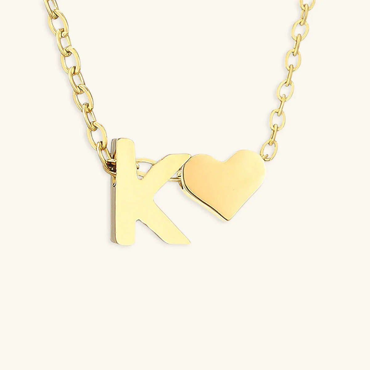 Seraya 14k yellow-gold PVD initial K and heart necklace on an ivory background