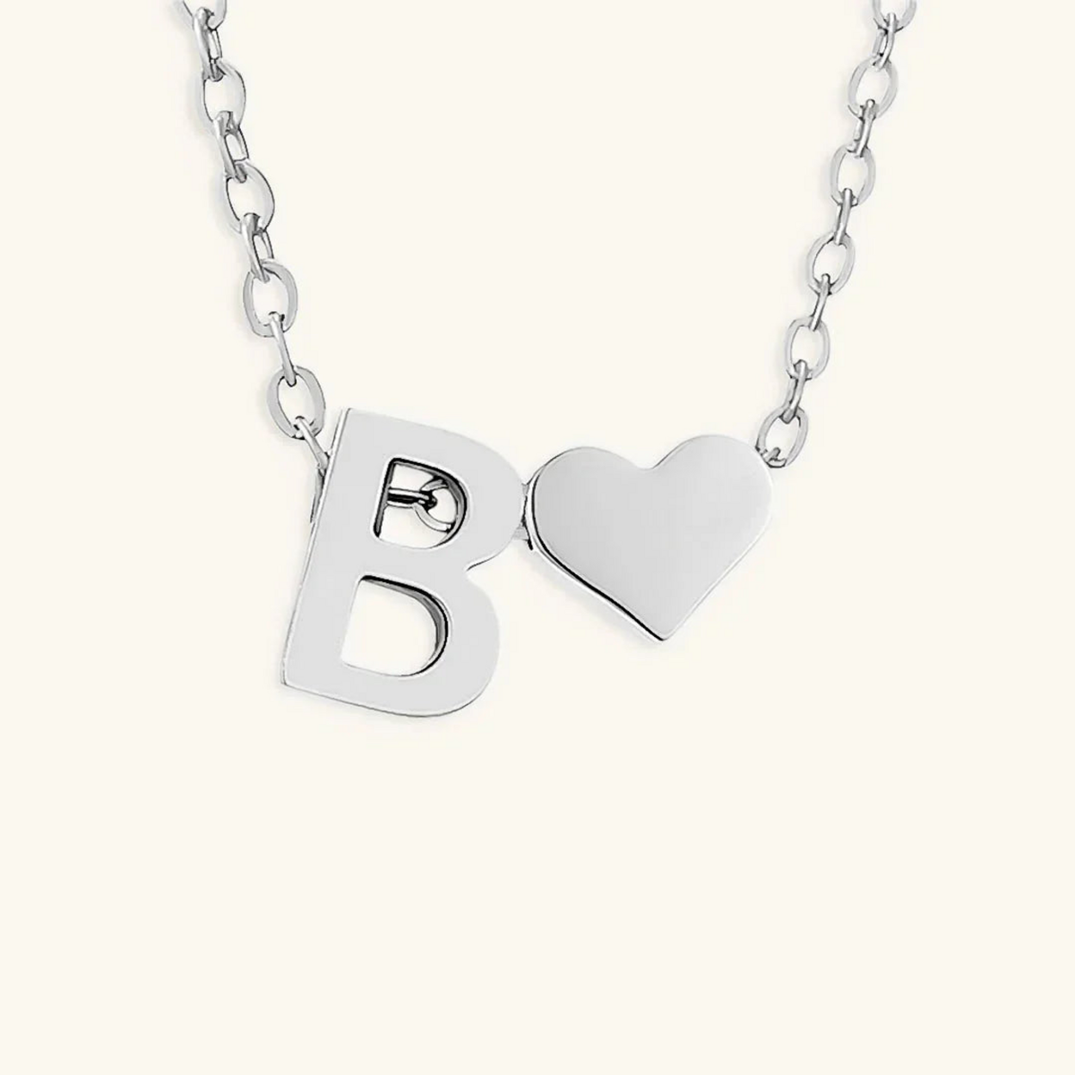 Seraya silver-tone initial B and heart necklace on an ivory background