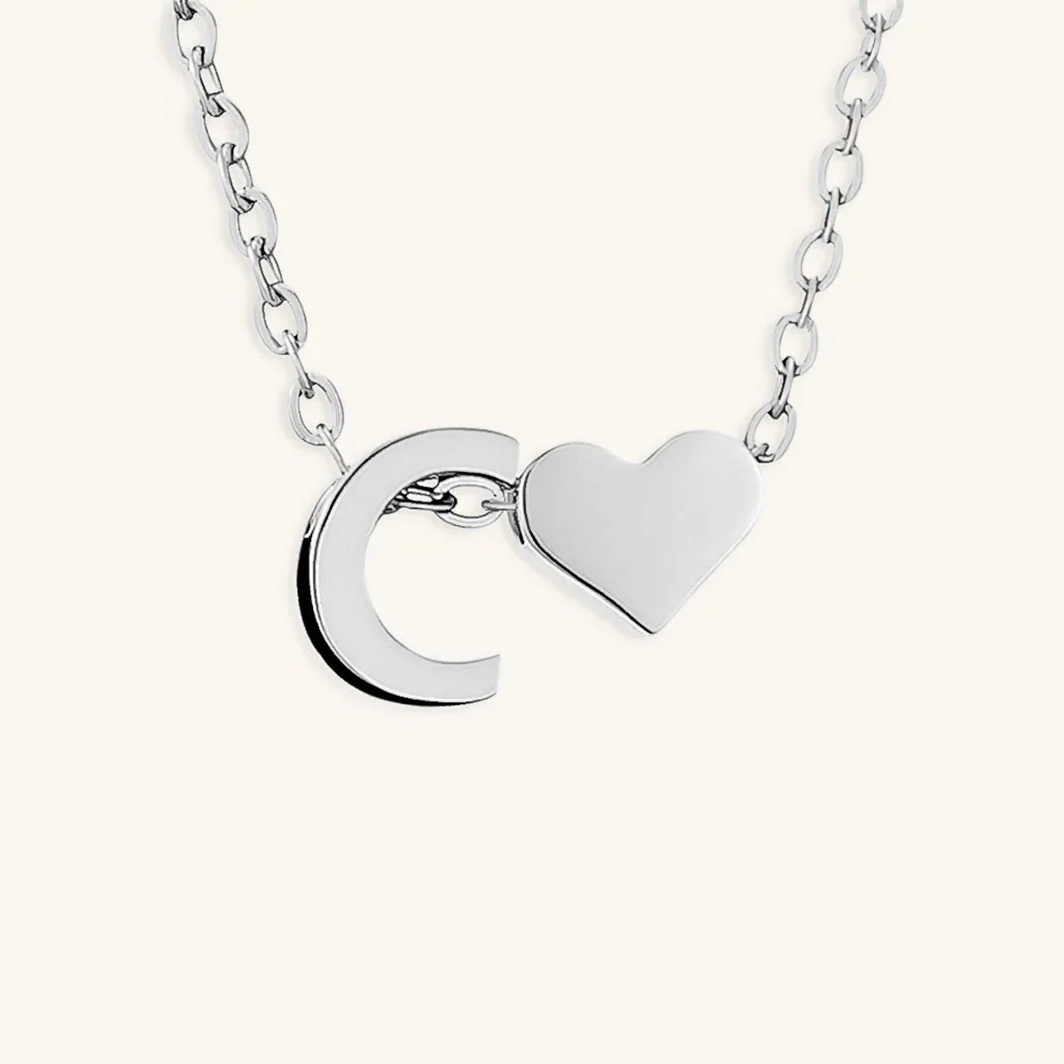 Seraya silver-tone initial C and heart necklace on an ivory background