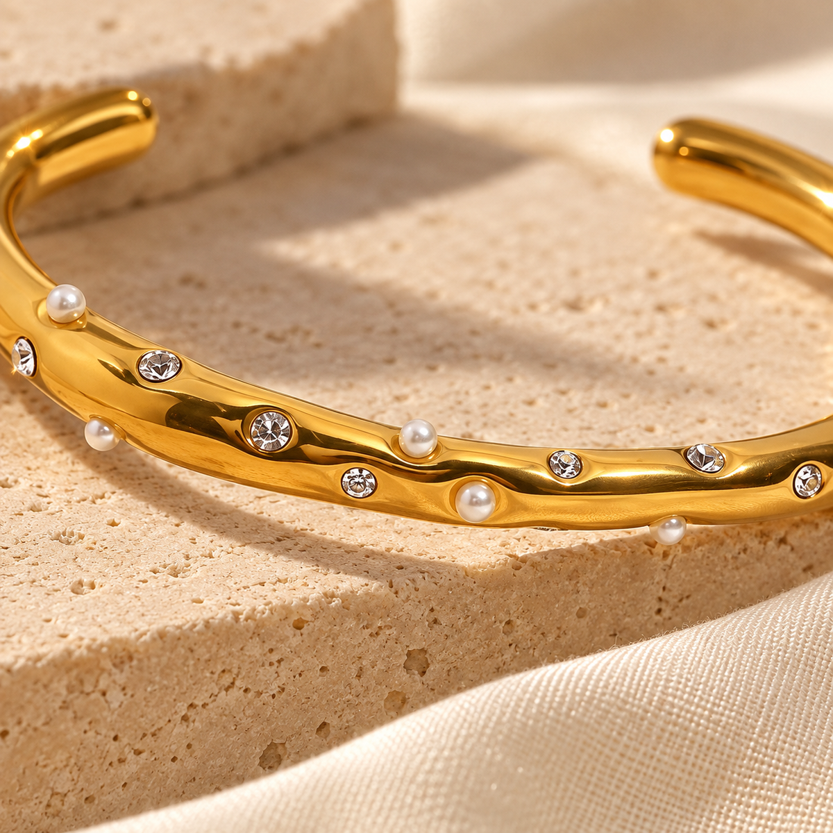 Close-up of Coravelle raised pearls, flush clear stones and organic gold band