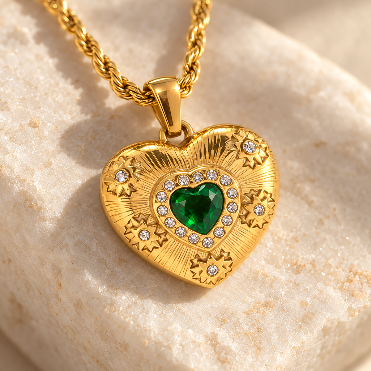 Elarisse engraved heart, green stone and raised rosette settings in detail