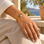 Elunara two-tone heart cable bracelet worn on an adult wrist