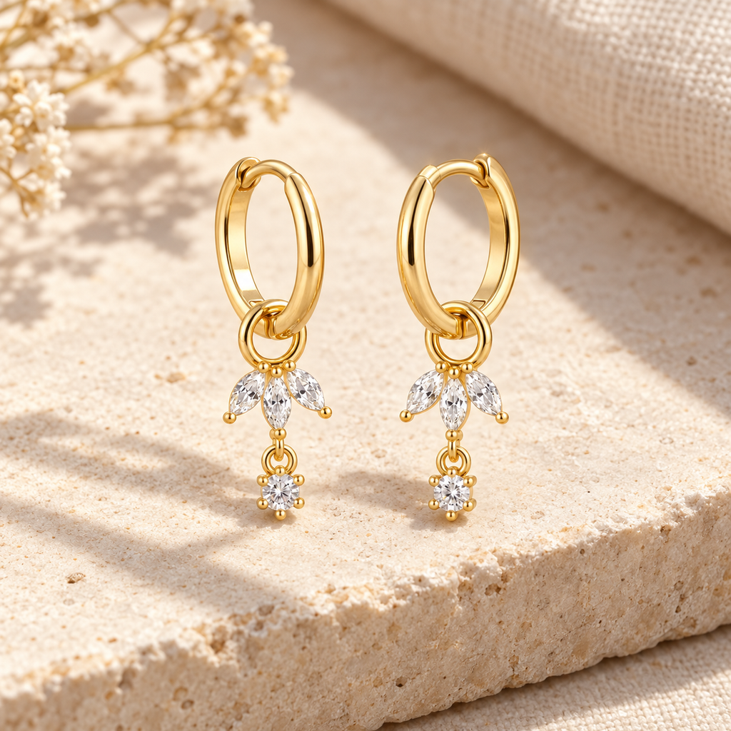 Pair of Liorenne gold hoops with three marquise stones and a round drop on each charm