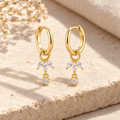Pair of Liorenne gold hoops with three marquise stones and a round drop on each charm