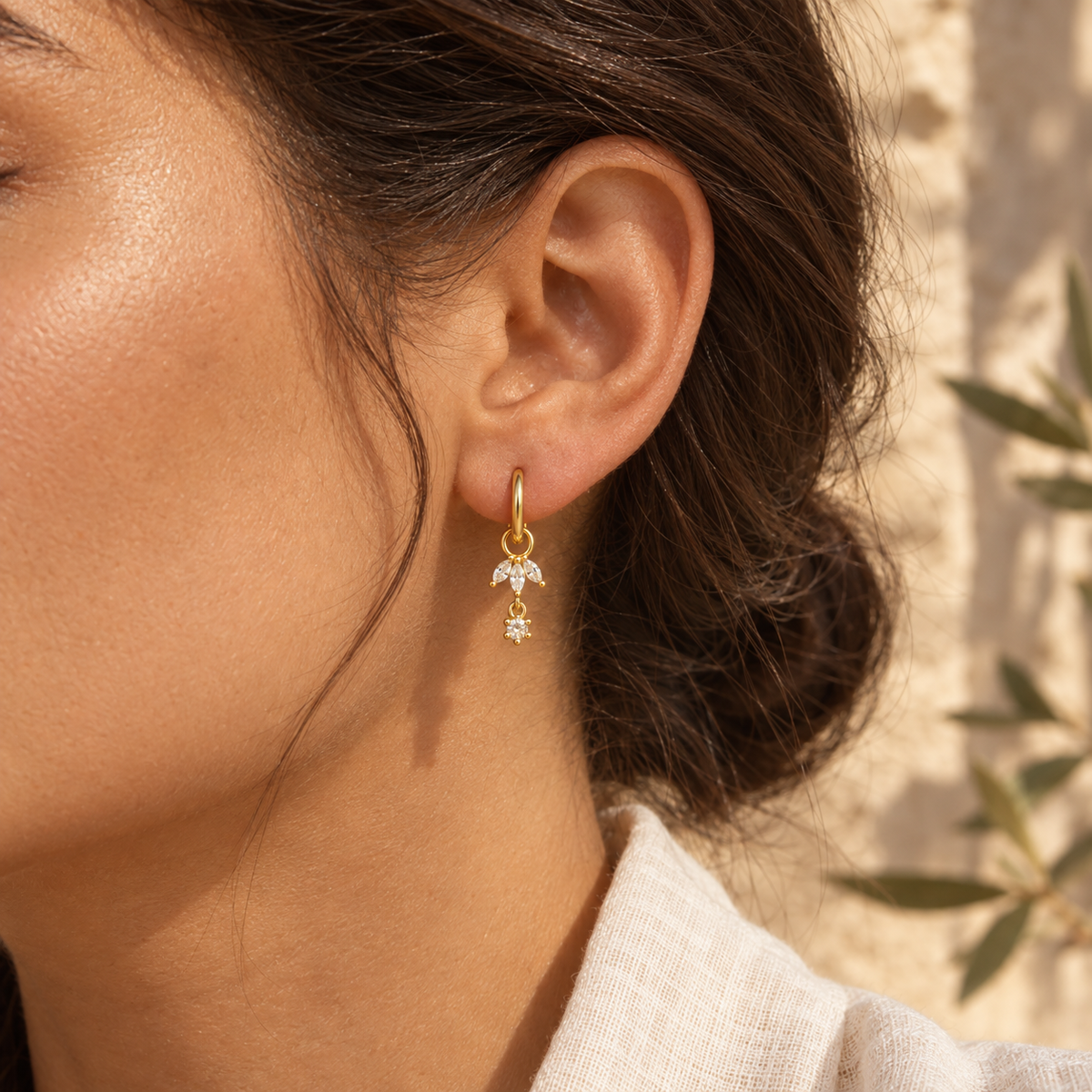 Liorenne small charm hoop worn through an adult earlobe